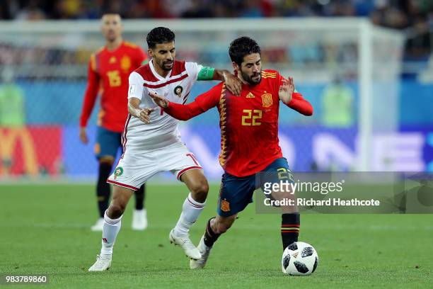 Isco of Spain is challenged by Mbark Boussoufa of Morocco during the 2018 FIFA World Cup Russia group B match between Spain and Morocco at...