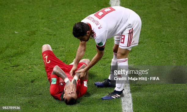 Ricardo Quaresma of Portugal is helped by Morteza Pouraliganji of Iran during the 2018 FIFA World Cup Russia group B match between Iran and Portugal...
