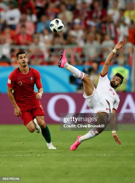 Ramin Rezaeian of Iran clearsthe bal under pressure from Andre Silva of Portugal during the 2018 FIFA World Cup Russia group B match between Iran and...