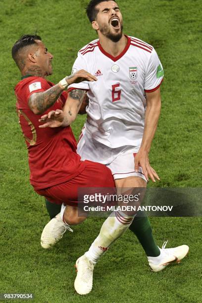 Iran's midfielder Saeid Ezatolahi is fouled by Portugal's forward Ricardo Quaresma during the Russia 2018 World Cup Group B football match between...