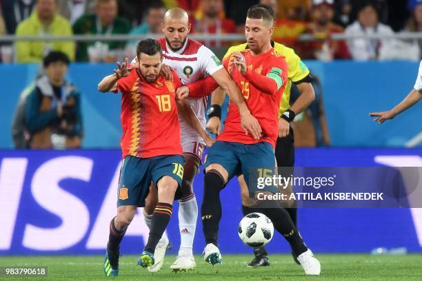 Morocco's forward Noureddine Amrabat vies with Spain's defender Jordi Alba and Spain's defender Sergio Ramos during the Russia 2018 World Cup Group B...