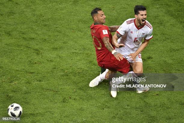 Iran's midfielder Saeid Ezatolahi is fouled by Portugal's forward Ricardo Quaresma during the Russia 2018 World Cup Group B football match between...