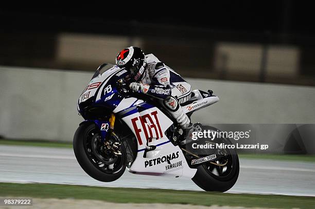 Jorge Lorenzo of Spain and Fiat Yamaha Team lifts his front wheel during the second day of testing ahead of the Qatar Grand Prix at Losail Circuit on...