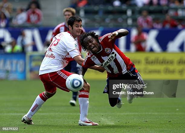 Chukwudi Chijindu of Chivas USA is fouled by Mike Petke of the New York Red Bulls on April 10, 2010 at the Home Depot Center in Carson, California....