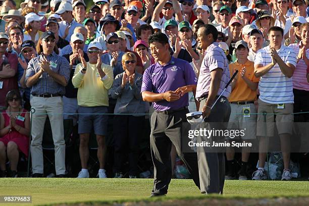 Tiger Woods shakes hands with K.J. Choi of South Korea after completeing the third round on the 18th hole during the 2010 Masters Tournament at...