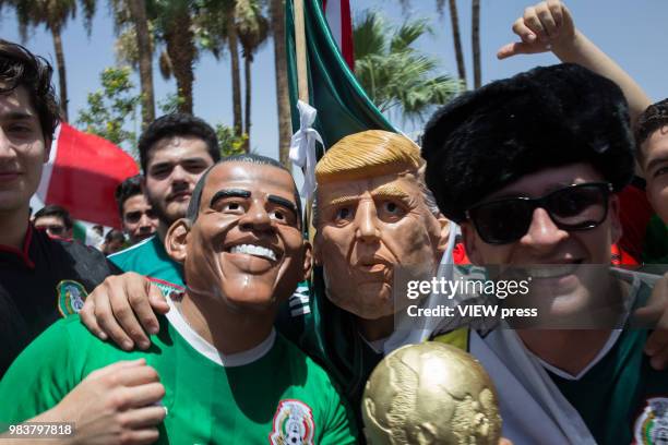 People celebrate with men masked as Former president Obama and President Trump after winning their FIFA World Cup - Group F - South Korea vs Mexico...