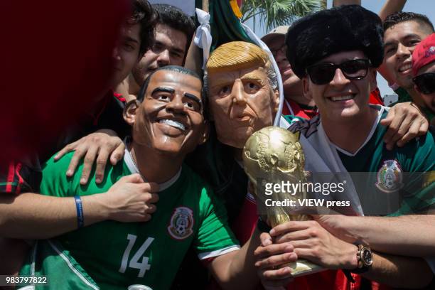 People celebrate with men masked as Former president Obama and President Trump after winning their FIFA World Cup - Group F - South Korea vs Mexico...