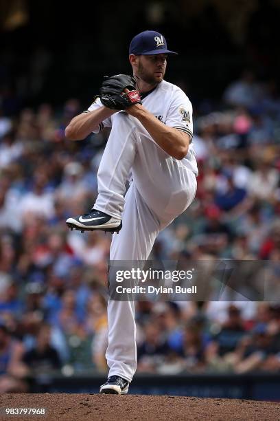 Adrian Houser of the Milwaukee Brewers pitches in the eighth inning against the St. Louis Cardinals at Miller Park on June 23, 2018 in Milwaukee,...