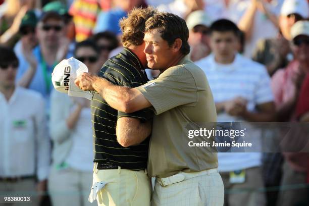 Ian Poulter of England and Lee Westwood of England shake hands after completing the third round on the 18th hole during the 2010 Masters Tournament...