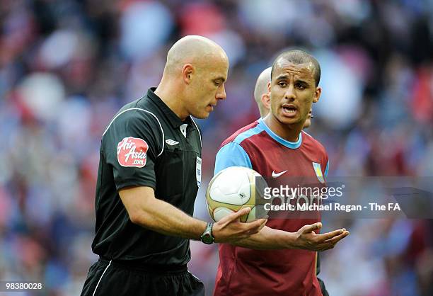 Gabriel Agbonlahor of Aston Villa speaks with referee Howard Webb as they walk off the pitch at half time during the FA Cup sponsored by E.ON Semi...