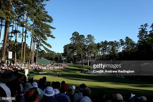Choi of South Korea lines up his putt on the 16th green as patrons look on during the third round of the 2010 Masters Tournament at Augusta National...