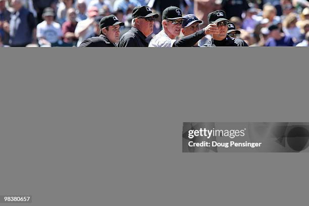 Manager Jim Tracy of the Colorado Rockies explains the ground rules to manager Bud Black of the San Diego Padres and the umpire crew of Mike DiMuro,...