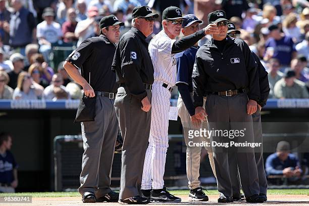 Manager Jim Tracy of the Colorado Rockies explains the ground rules to manager Bud Black of the San Diego Padres and the umpire crew of Mike DiMuro,...