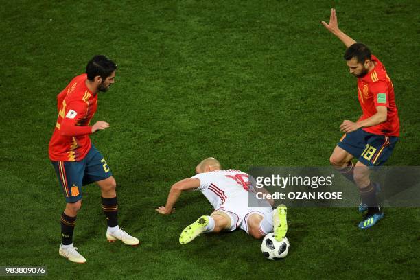 Morocco's forward Noureddine Amrabat lies between Spain's defender Dani Carvajal and Spain's defender Jordi Alba during the Russia 2018 World Cup...