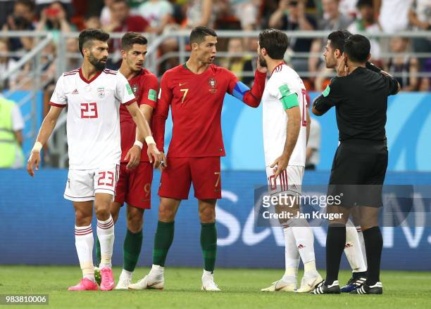 Cristiano Ronaldo of Portugal and Ramin Rezaeian of Iran argue with refere Enrique Caceres during the 2018 FIFA World Cup Russia group B match...