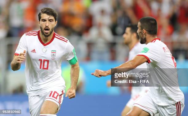 Karim Ansarifard of Iran celebrates with teammate Milad Mohammadi after scoring his team's first goal during the 2018 FIFA World Cup Russia group B...