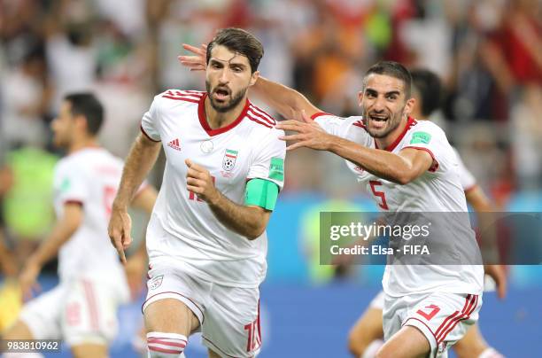 Karim Ansarifard of Iran celebrates with teammate Milad Mohammadi after scoring his team's first goal during the 2018 FIFA World Cup Russia group B...