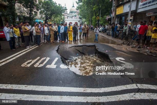 Road cave near Gol masjid, Marine lines on June 25, 2018 in Mumbai, India. Heavy downpour led to waterlogging at several places including roads in...