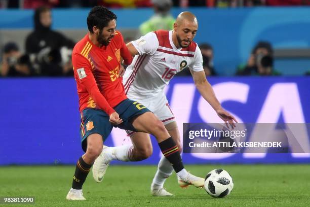 Spain's midfielder Isco vies with Morocco's forward Noureddine Amrabat during the Russia 2018 World Cup Group B football match between Spain and...