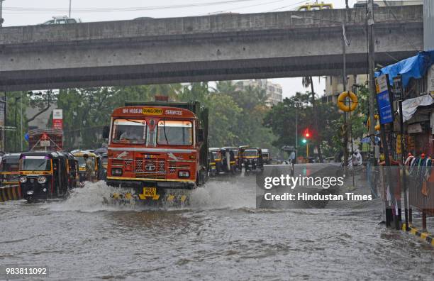 Vehicles wades through water logged street due to heavy rain at Saha Road, Andheri on June 25, 2018 in Mumbai, India. Heavy downpour led to...