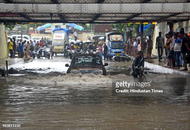 Vehicles wades through water logged street due to heavy rain at Milan Subway on June 25, 2018 in Mumbai, India. Heavy downpour led to waterlogging at...