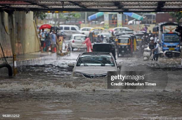 Vehicles wades through water logged street due to heavy rain at Milan Subway on June 25, 2018 in Mumbai, India. Heavy downpour led to waterlogging at...