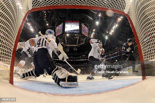 Alexander Frolov of the Los Angeles Kings battles for the puck infront of Devan Dubnyk of the Edmonton Oilers on April 10, 2010 at Staples Center in...