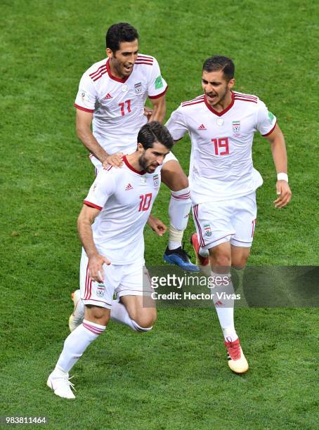 Karim Ansarifard of Iran celebrates with teammates Vahid Amiri and Majid Hosseini after scoring his team's first goal during the 2018 FIFA World Cup...