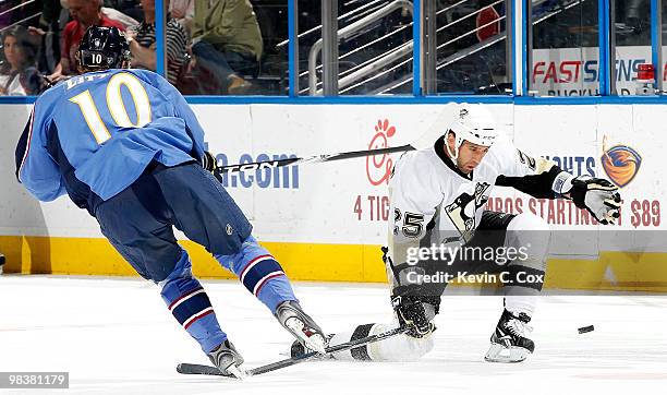 Maxime Talbot of the Pittsburgh Penguins kneels to block a pass by Bryan Little of the Atlanta Thrashers at Philips Arena on April 10, 2010 in...