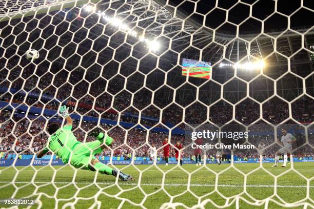 Karim Ansarifard of Iran scores past Rui Patricio of Portugal his team's first goal from the peanlty spot during the 2018 FIFA World Cup Russia group...