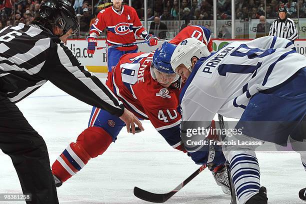 Maxim Lapierre of Montreal Canadiens facs off with Wayne Primeau of the Toronto Maple Leafs during the NHL game on April 10, 2010 at the Bell Center...