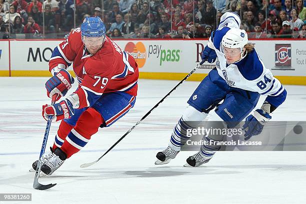 Andrei Markov of Montreal Canadiens skates with the puck in front of Mikhail Grabovski of the Toronto Maple Leafs during the NHL game on April 10,...