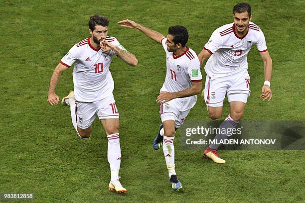 Iran's forward Karim Ansari Fard celebrates scoring a penalty with his teammates during the Russia 2018 World Cup Group B football match between Iran...