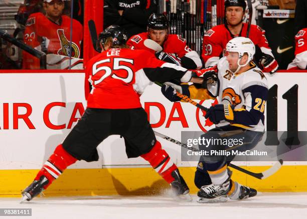 Brian Lee of the Ottawa Senators knocks Thomas Vanek of the Buffalo Sabres to the ice at the blueline during a game at Scotiabank Place on April 10,...