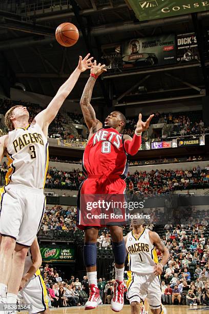 Terrence Williams of the New Jersey Nets shoots over Troy Murphy of the Indiana Pacers at Conseco Fieldhouse on April 10, 2010 in Indianapolis,...