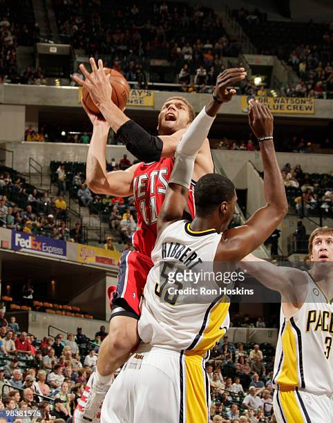 Brooke Lopez of the New Jersey Nets shoots over Roy Hibbert of the Indiana Pacers at Conseco Fieldhouse on April 10, 2010 in Indianapolis, Indiana....
