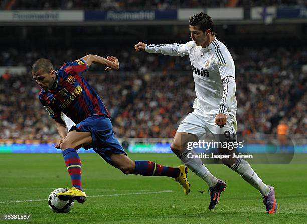 Cristiano Ronaldo of Real Madrid fights for the ball with Daniel Alves of FC Barcelona during the La Liga match between Real Madrid and Barcelona at...