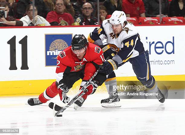 Mike Fisher of the Ottawa Senators stickhandles the puck against Steve Montador of the Buffalo Sabres at Scotiabank Place on April 10, 2010 in...
