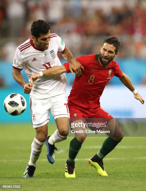 Joao Moutinho of Portugal and Vahid Amiri of Iran in action during the 2018 FIFA World Cup Russia group B match between Iran and Portugal at Mordovia...