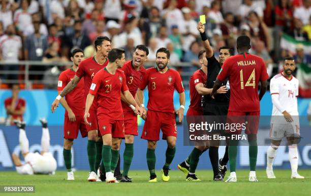 Enrique Caceres shows a yellow card to Cedric of Portugal during the 2018 FIFA World Cup Russia group B match between Iran and Portugal at Mordovia...