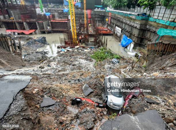 Several cars struck in debris after a wall collapsed at a construction site in Antop Hill, Wadala East area on June 25, 2018 in Mumbai, India. Around...