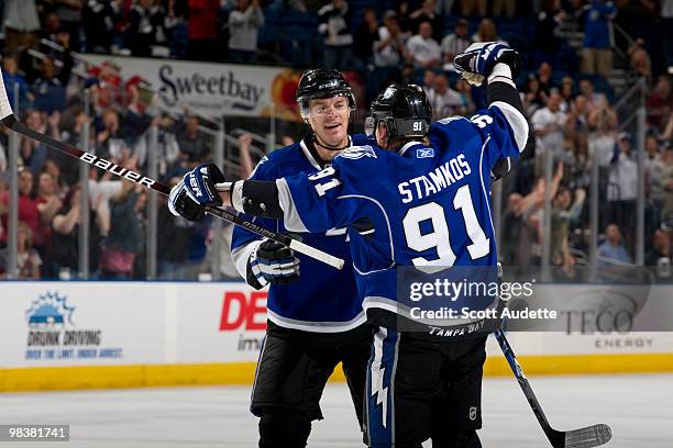 Steven Stamkos of the Tampa Bay Lightning celebrates his 49th goal of the season with teammate Kurtis Foster in the first period against the Florida...