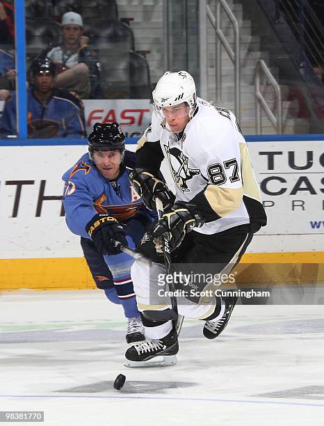 Sidney Crosby of the Pittsburgh Penguins battles for the puck against Slava Kozlov of the Atlanta Thrashers at Philips Arena on April 10, 2010 in...