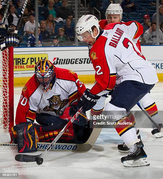 Keith Ballard of the Florida Panthers clears the puck in front of goaltender Scott Clemmensen during the first period against the Tampa Bay Lightning...