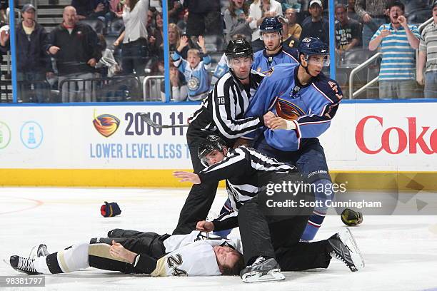 Evander Kane of the Atlanta Thrashers is restrained by referees after his fight against Matt Cooke of the Pittsburgh Penguins at Philips Arena on...