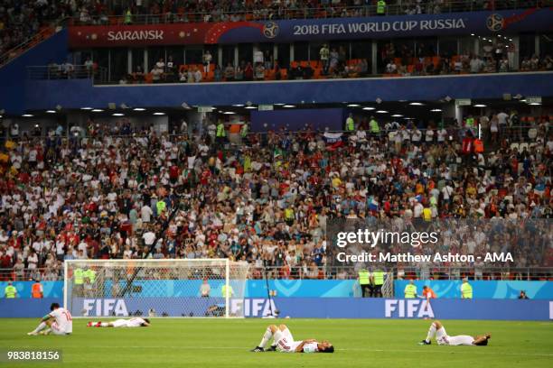 The IR Iran players lie dejectedly on the pitch at the end of the 2018 FIFA World Cup Russia group B match between Iran and Portugal at Mordovia...