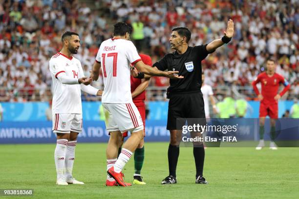 Saman Ghoddos and Mehdi Taremi of Iran argue with Referee Enrique Caceres during the 2018 FIFA World Cup Russia group B match between Iran and...