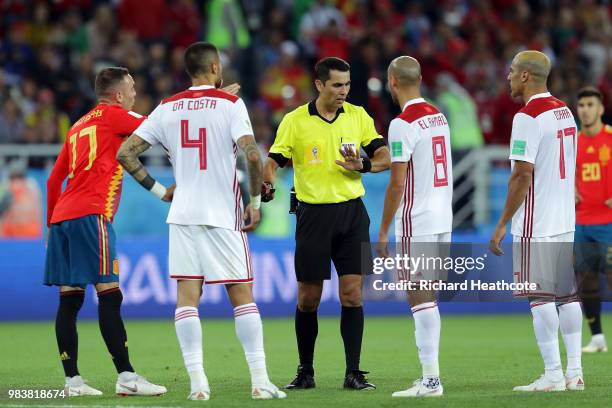 Referee Ravshan Irmatov speaks with Manuel Da Costa of Morocco and Karim El Ahmadi of Morocco during the 2018 FIFA World Cup Russia group B match...