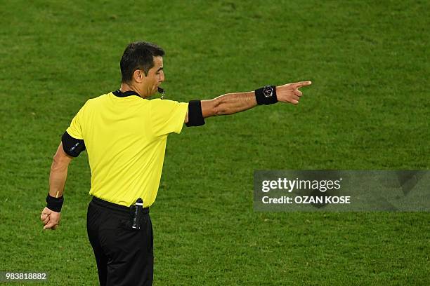 Uzbek referee Ravshan Irmatov blows thw whistle to confirm Spain's second goal confirmed by VAR during the Russia 2018 World Cup Group B football...