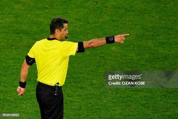 Uzbek referee Ravshan Irmatov blows thw whistle to confirm Spain's second goal confirmed by VAR during the Russia 2018 World Cup Group B football...